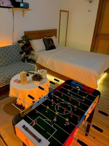 a room with a bed and a table with a game at Sea Star Hotel Quy Nhon in Quy Nhon