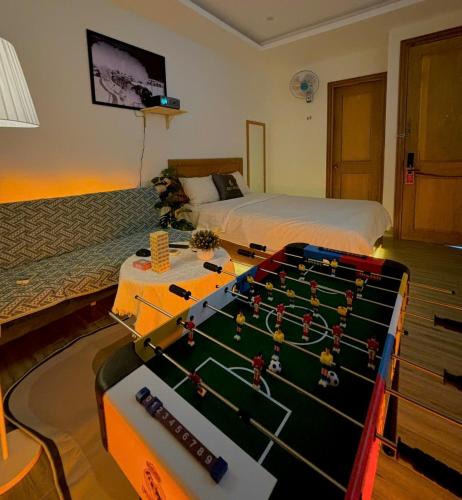a room with a bed and a pool table at Sea Star Hotel Quy Nhon in Quy Nhon