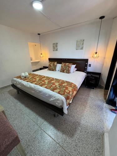 Ένα ή περισσότερα κρεβάτια σε δωμάτιο στο Hotel Volcán Campestre Guatapé