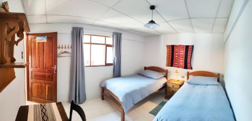Ένα ή περισσότερα κρεβάτια σε δωμάτιο στο Hostal Margaritas - Torotoro