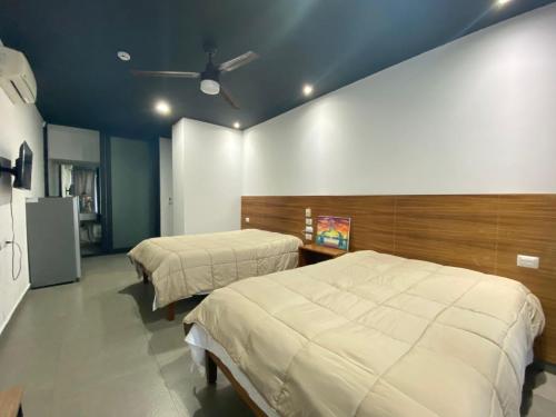 a room with two beds in a room at Mía Center hotel in Playa del Carmen