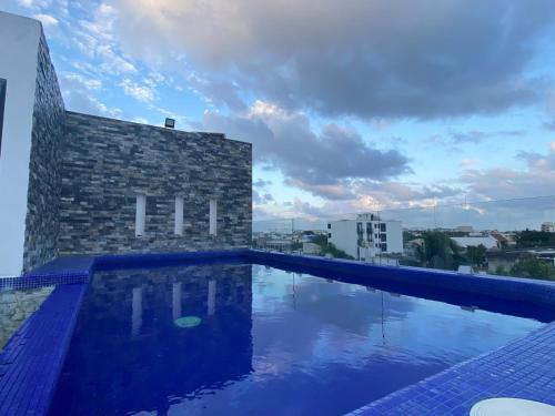 a swimming pool on the roof of a building at Mía Center hotel in Playa del Carmen