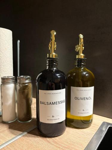 two bottles of oils sitting on a table at Modernes Serviced Apartment - FeWo Morgenglanz in Berchtesgaden