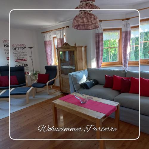 a living room with a blue couch and a table at Chalet Glücklich sein... in Ellmau