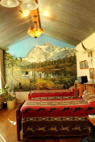 a bedroom with a mountain mural on the wall at K3 Guest Ranch in Cody