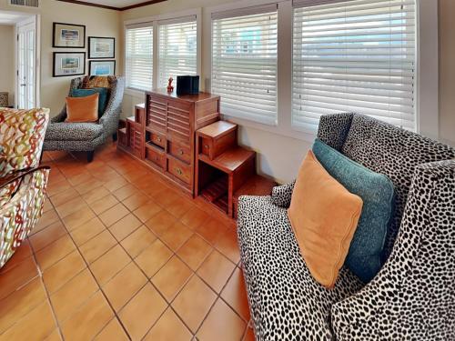 a living room with two couches and a table at The Hidden Porpoise in Port Aransas