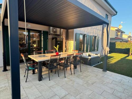a patio with a table and chairs under awning at Villa Luciana Spa House, Buje in Buje