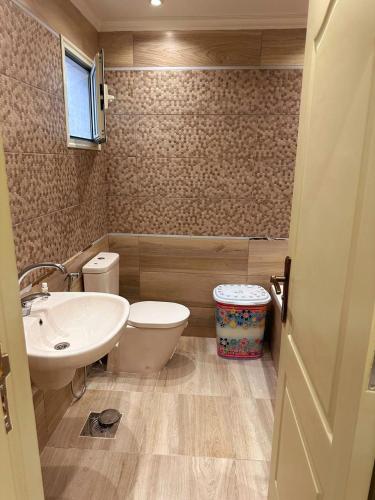 a bathroom with a toilet and a sink at دوبليكس فاخر فيلا للايجار مفروش في ارقي اماكن لوران in Alexandria