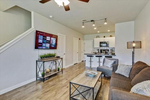 a living room with a couch and a table at Modern W Pool, Gym, HotTub, Golf, Pet Friendly in Draper