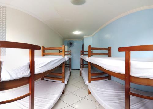 a room with three bunk beds in it at Hostel Preservar in Cabo Frio