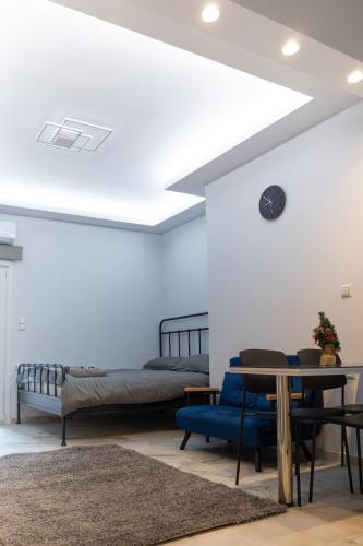 a bedroom with a bed and a table and chairs at Elario studio in Larisa