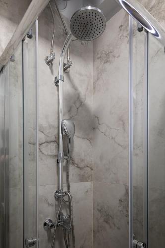 a shower with a shower head in a bathroom at Elario studio in Larisa
