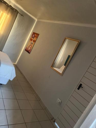 a bedroom with a bed and a mirror on the wall at RCB guesthouse in Burgersfort