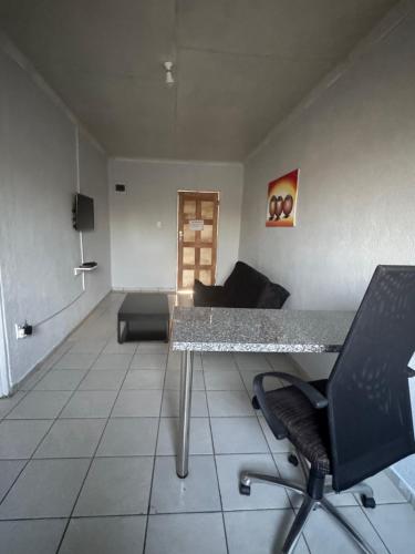 a living room with a table and a couch at RCB guesthouse in Burgersfort