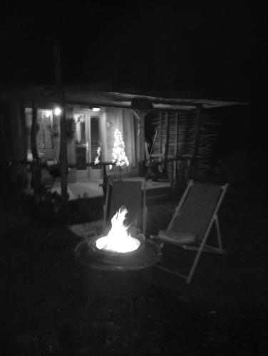a fire pit in front of a house at night at La maison du pêcheur in Saint-Justin