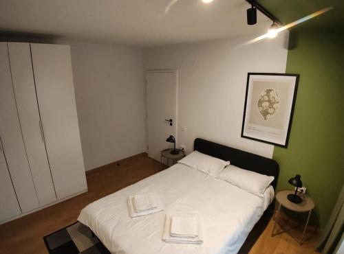 a bedroom with a white bed with two books on it at Christians Haus in Târgu-Mureş