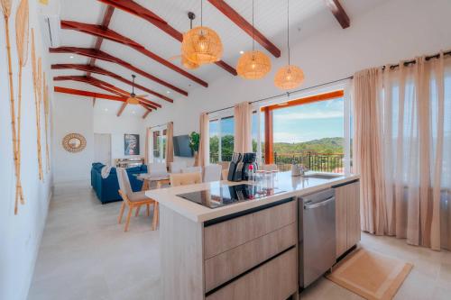 a kitchen and living room with a table and chairs at Spacious Bright & Airy Penthouse G at Playa Venao in Playa Venao