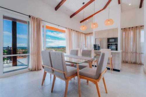 a dining room with a table and chairs with a view at Spacious Bright & Airy Penthouse G at Playa Venao in Playa Venao
