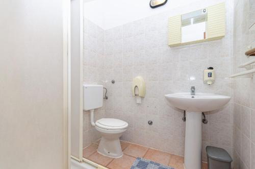 a bathroom with a toilet and a sink at Apartments Franka in Klek
