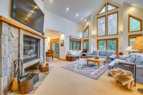 a living room with a large stone fireplace at Spacious Dover Refuge about 5 Mi to Mount Snow! in Dover
