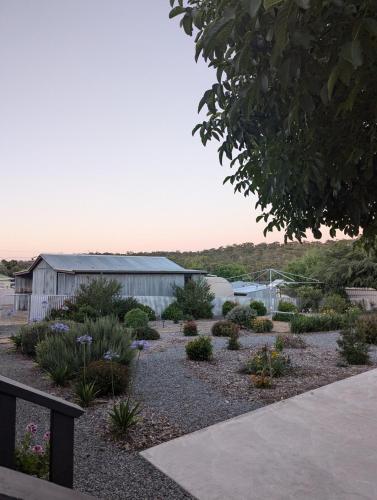a garden with flowers and plants in front of a building at Clare Cottage with 3 King Suites in Clare