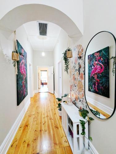 a hallway with a mirror on the wall at Clare Cottage with 3 King Suites in Clare
