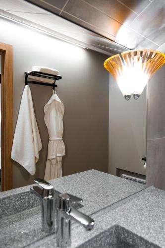 a bathroom with a sink and a mirror at Гуманист Бутик-отель in Karagandy