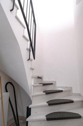 a staircase in a room with white walls at Maisonette 1 in Bad König