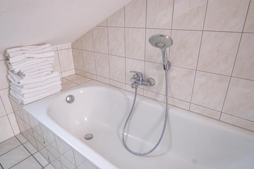a bath tub with a shower in a bathroom at Maisonette 1 in Bad König