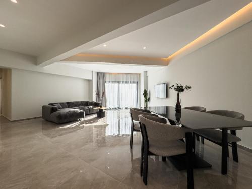 a living room with a table and chairs and a couch at VILLA 8 By ProLiving Hospitality in Thessaloniki