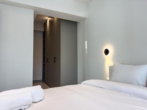 a bedroom with a large white bed with white sheets at VILLA 8 By ProLiving Hospitality in Thessaloniki
