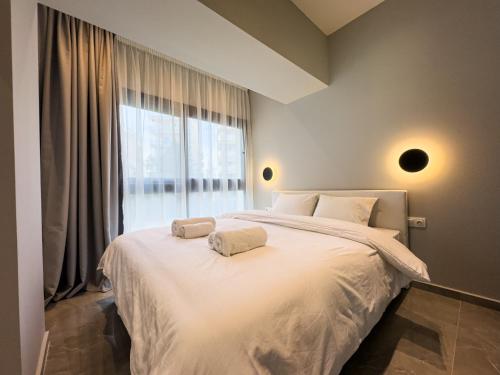 a bedroom with a white bed with a large window at VILLA 8 By ProLiving Hospitality in Thessaloniki