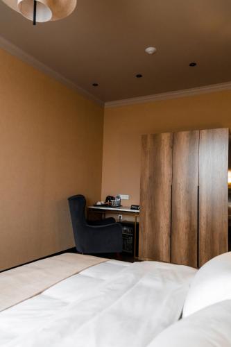 a hotel room with a bed and a desk at Гуманист Бутик-отель in Karagandy