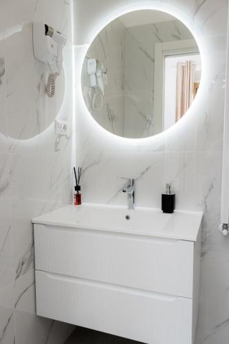 a white bathroom with a sink and a mirror at Green Garden in Rome