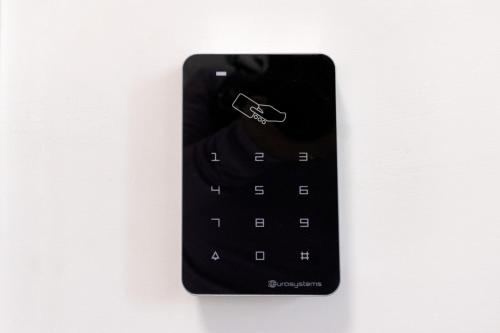 a black remote control hanging on a wall at Green Garden in Rome