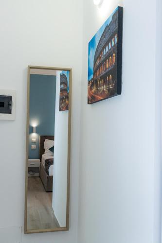 a mirror on a wall in a room with a bed at Green Garden in Rome