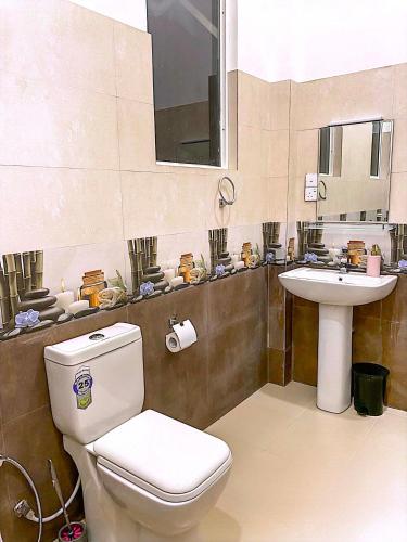 a bathroom with a toilet and a sink at Shalom Resorts Yala in Tissamaharama
