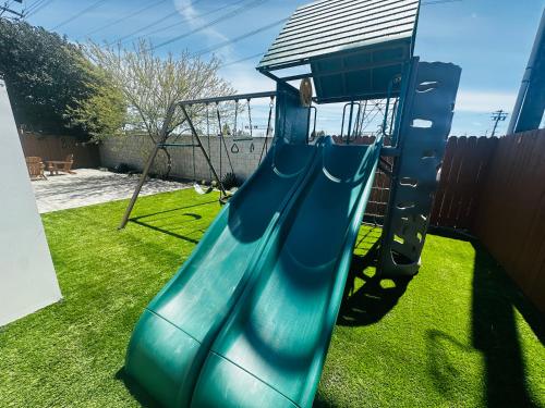 a blue slide in a yard with grass at Luxury Disneyland Home: Family & Exec Friendly in Anaheim