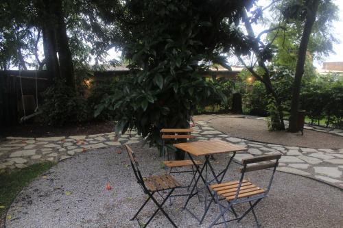 a picnic table and chairs sitting in a garden at Casa Chavela in Tepoztlán