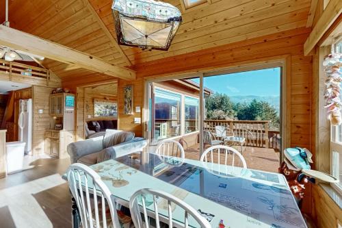 a dining room and living room with a table and chairs at The Magical Forested Sea Cove in Carpenterville