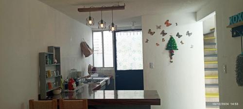 a room with a table and a christmas tree on the wall at ZIHUA TAANAJ in Zihuatanejo