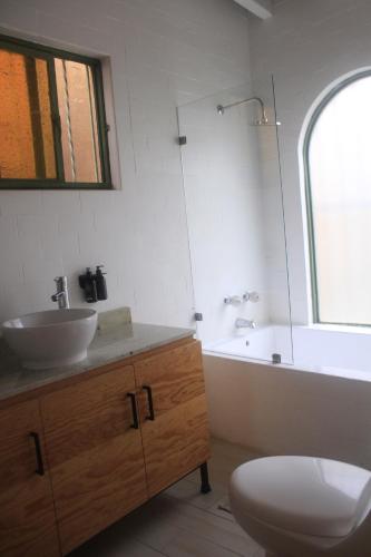 a bathroom with a sink and a tub and a toilet at Casa Chavela in Tepoztlán