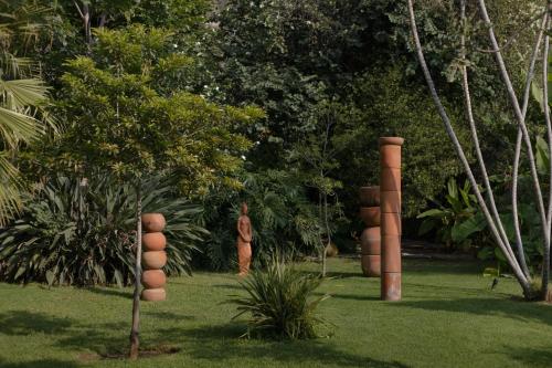 a garden with a bunch of sculptures in the grass at Casa Chavela in Tepoztlán