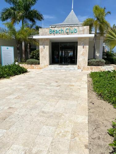 a beach club building with palm trees in front of it at Apartment in Playa Nueva Romana in San Pedro de Macorís