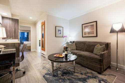 a living room with a couch and a table at Executive Suites Hotel & Conference Center, Metro Vancouver in Burnaby