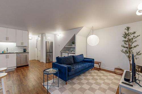 a living room with a blue couch and a kitchen at Portland Blues in Portland