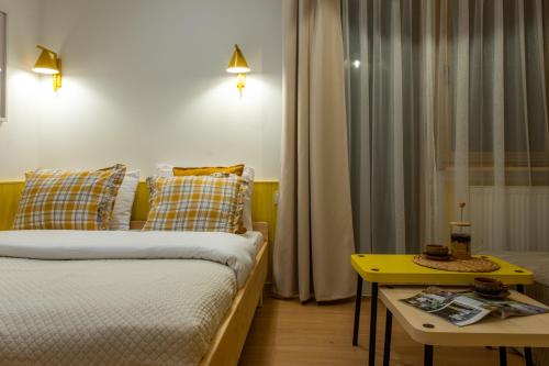 a small room with a bed and a table at Panocek i Babka in Białka Tatrzanska