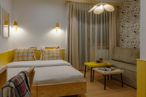 a small bedroom with a bed and a couch at Panocek i Babka in Białka Tatrzanska