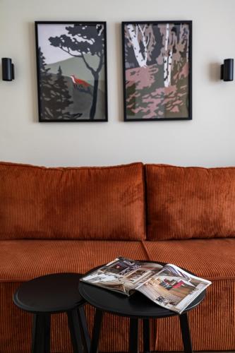 a living room with a couch and a table with a newspaper on it at Panocek i Babka in Białka Tatrzanska