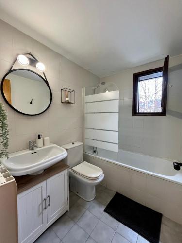 a bathroom with a sink toilet and a mirror at Estudio Las Perseidas - Vall de Boí in Pla de l'Ermita